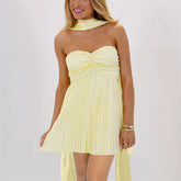 Women's yellow strapless pleated mini dress with neck scarf.